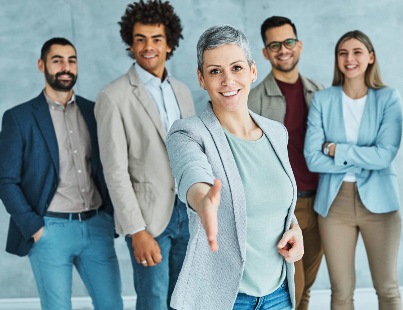 Group of young business people having a meeting shaking hands handshake introducing each other in the office. Teamwork and success concept